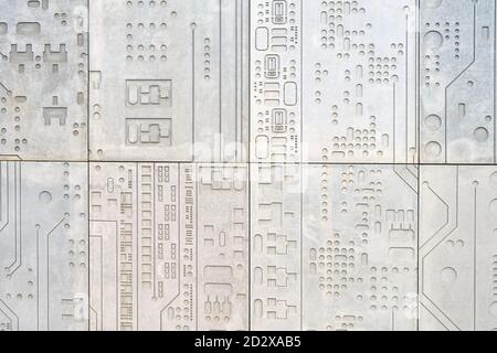 Concrete wall background with a print of a computer chip, modern electronics in stone Stock Photo