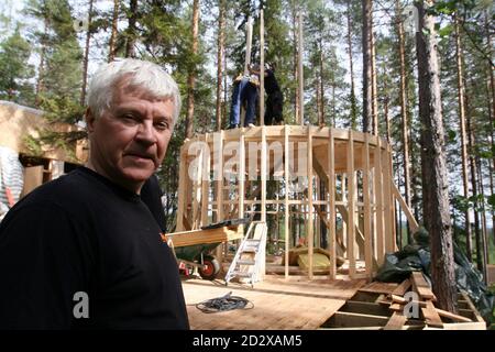 Treehotel co-founder Kent Lindvall poses for a picture in front of the TreeSauna on the construction site of Treehotel in the Swedish village of Harads, July 5, 2010. A lofty new hotel concept is set to open in a remote village in northern Sweden, which aims to elevate the simple treehouse into a world-class destination for design-conscious travellers. Treehotel, located in Harads about 60 km south of the Arctic Circle, will consist of four rooms when it opens on July 17th: The Cabin, The Blue Cone, The Nest and The Mirrorcube. Picture taken July 5, 2010.     To match Reuters Life! SWEDEN-TREE