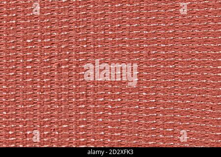 Scene curtain fabric background with metal weave. Rough woven red material with shiny inserts. Texture of coarse curtain fabric with interwoven silver Stock Photo