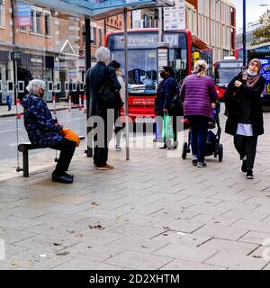 London UK October 06 2020, People Walking And Queuing For A Single Decker Red London Bus During COVID-19 Stock Photo