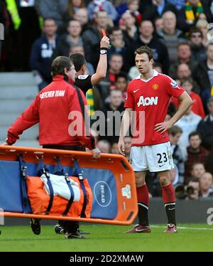 Referee Andre Marriner shows the red card to Manchester United's Jonny Evans Stock Photo