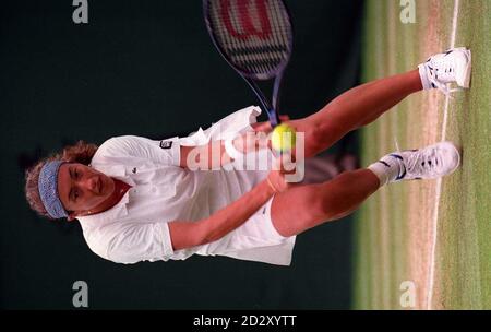 France's Sandrine Testud stoops for a low ball from Monica Seles