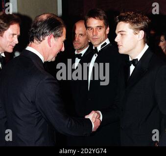 The Prince of Wales (left) shakes hands with Titanic star Leonardo DiCaprio at the Royal Premiere of 'The Man in the Iron Mask' at the Odeon Leicester Square. Stock Photo
