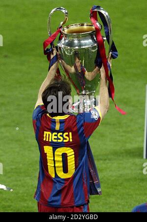 Barcelona's Lionel Messi Celebrates With The Champions League Trophy ...