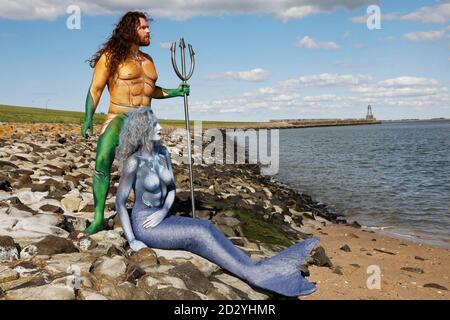 From the FARBKORPER calendar 2021 - Geek Art-Bodypainting and Transformaking: Aquaman and Nixe Photoshooting with Grave Artist and Janina S. at the Jadebusen in Wilhelmshaven. A project by the photographer Tschiponnique Skupin and the body painter and transformaker Enrico Lein | usage worldwide Stock Photo