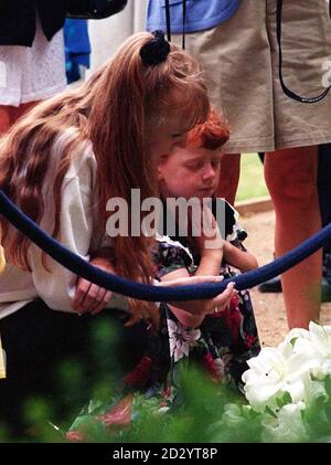 A young child prays at the Temple to Diana, Princess of Wales near the Oval in the grounds her family's estate at Althorp where around 2,500 people arrived to pay their respects as the park gates opened for the first time since her death today (Wednesday). See PA story DIANA Althorp. Picture DAVID JONES/PA Stock Photo