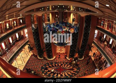 The main lobby of the new Disney cruise ship, the Disney Magic, which can accommodate 2,400 guests on its eleven passenger decks. The ship is a new direction for the company, better known for its entertainment and theme parks. The seven-day holiday packages combine a three or four day trip to Walt Disney World in Florida with a three or four day cruise in the Bahamas. The 83,000-ton vessel, one of the biggest in the world, will sail from Port Canaveral in Florida, call at the historic Port of Nassau and spend a day at Disney's own private pleasure island in the Bahamas, Castaway Cay. Picture b Stock Photo