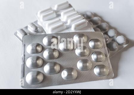 Pile of medicine blisters on white isolated background,health care medical tools Stock Photo
