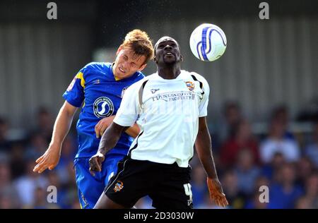 Wimbledon's (left) Max Porter and Port Vales' Anthony Griffith compete for a header during the npower Football League Two match at the Cherry Red Records Fans' Stadium Kingsmeadow in London. Stock Photo