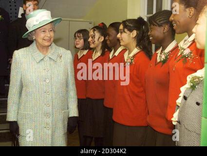 Britain's Queen Elizabeth II passes pupils during a visit to the St-Martin-in-the-Fields High School for Girls in Tulse Hill, south London.  Her visit marked the 300th anniversary of the school, where nearly nine in 10 of the 600 pupils come from ethnic backgrounds.    * The school has hosted a royal visit in the past ... the Queen Mother visited it 70 years ago. Stock Photo