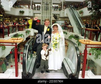 Britains first ever marriage in a shopping mall took place in Redhill, Surrey with the wedding of Debbie Lane and Damian Clapp. Debbie and Damian are joined by pageboy Tosh in the Belfry shopping centre. Stock Photo