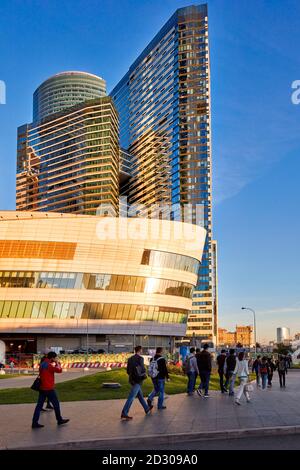 People walking near high-rise buildings of Moscow International Business Centre (MIBC, also known as Moscow City). Moscow, Russia. Stock Photo