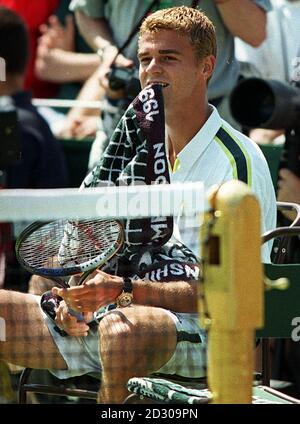 No Commercial Use. Gustavo Kuerten of Brazil bites his towel after losing the first game to America's Andre Agassi during his quarter final match at Wimbledon.  20/04/04: Brazil's Gustavo Kuerten who is sitting out of his country's Davis Cup campaign in protest at the continued reign of national federation chief Nelsonn Nastas. Stock Photo