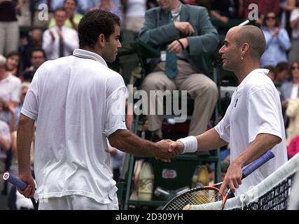 No Commercial Use. America's Pete Sampras (left) shakes hands with Andre Agassi after Sampras won the Men's Singles at Wimbledon. Sampras defeated Agassi 6-3 6-4 7-5. Stock Photo