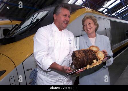 Top chef, Brian Turner with Deputy Agriculture Minister, Joyce Quin with a platter of British Beef, before boarding the Eurostar train at Waterloo station. The two ribs of prime beef on it's way to a lunch hosted by the Meat and Livestock Commission in Brussels. Stock Photo