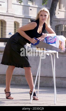 Emma Noble, wife of former Prime Minister John Major's son James, gives her ironing the saw treatment, as she launches a new product from Lenor, that will  help cut the time of ironing the laundry in half, during a photocall held in London. Stock Photo