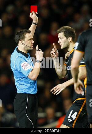 Wolverhampton Wanderers' Roger Johnson (right) complains about the sending off of teammate Nenad Milijas as referee Stuart Attwell (left) shows the red card Stock Photo