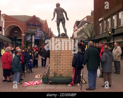 Fans gather to lay flowers, cards and football scarves in tribute to Sir Stanley Matthews, at a statue of the star at the Potteries shopping centre in Hanley, Stoke-on-Trent.  The former Blackpool and Stoke City winger died aged 85,  after a short illness. Stock Photo