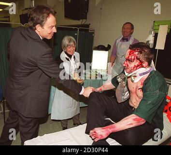 British Prime Minister Tony Blair meets a member of staff of the College, who is made up to look like a trauma patient during his visits to the Royal College of Surgeons in central London. Stock Photo