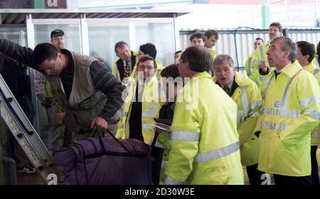 British Home Secretary Jack Straw (right) watches as a stowaway is helped down from the rear of a lorry at Dover Docks.  Seven others were found in this lorry and one in another during the visit by Mr Straw to the immigration service at the port of Dover.  *  it is one of the main points of entries for illegal immigrants. Mr Straw went to the Kent port to see how new financial penalties he introduced  for drivers found bringing illegal immigrants into this country are working. Stock Photo