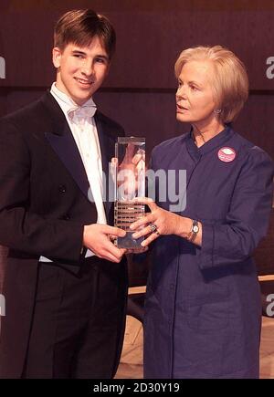 18 year old Guy Johnston receives his trophy from the Duchess of Kent for winning the BBC Young Musician of the Year 2000 competition, at the Bridgewater Hall in Manchester.   * One of Guy's strings broke at the start of his performance but he managed to keep his composure, changing the string and carrying on to win. Stock Photo