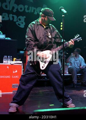 Singer Jimmy Pop Ali of American hip-hop rock band the Bloodhound Gang, strikes a pose with his guitar on stage at the Astoria, London. Stock Photo