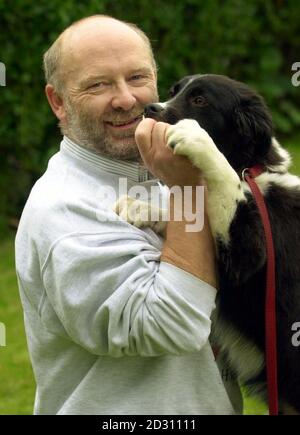 New owner John Easton from Colliston near Aberdeen, who works for the Search and Rescue Dogs Association, greets Merlin, a puppy that belonged to the BBC Castaways on the island of Taransay, pictured at the Scottish SPCA centre in Milton near Glasgow.  * Merlin, who is one of a litter of six puppies born on the island, will be renamed 'Sico' after an ex-climber and will be trained as a rescue dog at his new home. Picture by Ben Curtis/PA.  **EDI** Stock Photo