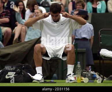 NO COMMERCIAL USE: America's Pete Sampras fiddles with his ears during a break in his tennis match against Karol Kucera of Slovakia at Wimbledon. Stock Photo