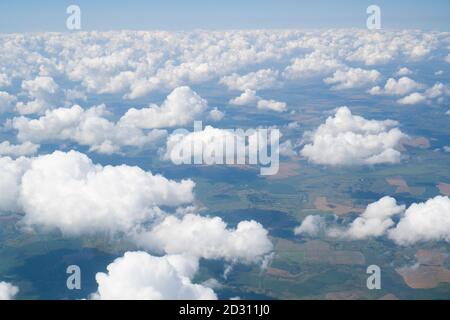 Bright horizon from an airplane. Aerial view of beautiful small white clouds. Window seat view. Light background. High quality photo Stock Photo
