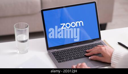 Laptop showing Zoom Cloud Meetings app logo Stock Photo