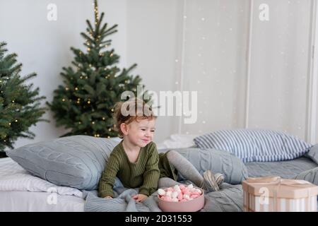 Cozy bed with Christmas pillows decorated with Christmas decor Stock Photo  - Alamy