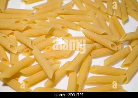 Close up view of uncooked penne pasta,italian healthy kitchen food background Stock Photo