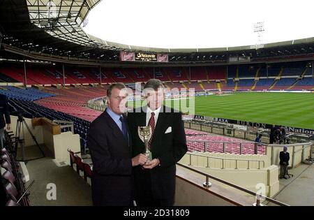 Sir Geoff Hurst (left) and Martin Peters, with a replica of the 1966 world cup,  say farewell to Wembley,  on the eve of the final match to be played there, which happens to be an England v Germany clash repeating the fixture of the 1966 World Cup Final.  *   in which both  played a key part in England's infamous win. Stock Photo