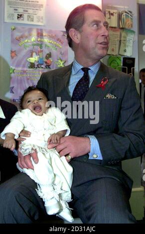 The Prince of Wales meets 18 week old Saharra Henry and the baby's mother Chrystel, when he visited Alone in London. Alone in London is a charity which helps the young homeless in London. Stock Photo