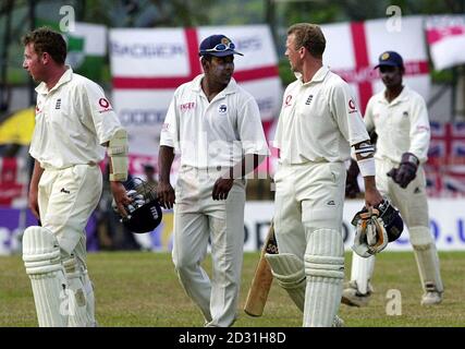England batsman Robert Croft (left) walks off as Sri Lankan bowler Chaminda Vaas exchanges words with Alec Stewart at the end of play on the fourth day of the 2nd Test at the Asgiriya Stadium, Kandy, Sri Lanka. Stock Photo