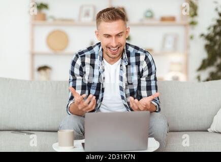 Happy man using laptop for video call and talking Stock Photo