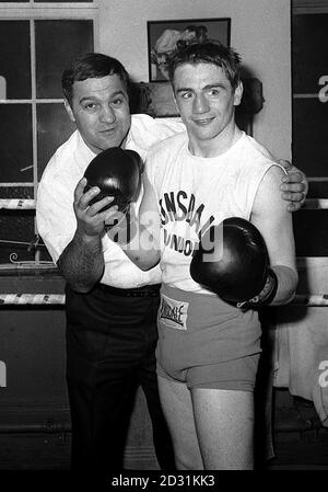 American boxing champion Rocky Marciano, who retired as undefeated World Heavyweight champion, shows new British professional Pat Dwyer how to lead, at the Cambridge gym, in London, in 1965. Stock Photo