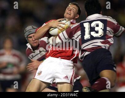 British and Irish Lion Matt Perry gets a high tackle from President's XV's Junior Pelesasa during the British and Irish Lions International Tour game at the Dairy Farmers Stadium, Townsville. Stock Photo