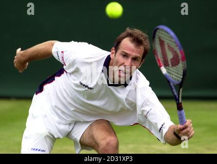 NO COMMERCIAL USE : Great Britain's Greg Rusedski in action against Byron Black of Zimbabwe during the Second Round match of the 2001 Lawn Tennis Championships at Wimbledon, London. Stock Photo