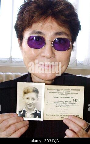 Musician and artist Yoko Ono, widow of Beatles singer John Lennon, holds aloft a picture of her late husband, when he was a youngster in Liverpool. Stock Photo