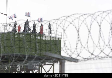 Some of more than 100 peace protesters who broke into major British defence site Menwith Hill Base, near Harrogate, occupying the Water Tower inside base. Greenpeace said its activists entered the spy base to protest against US plans. * ...to use it as part of its Son of Star Wars national missile defence programme. North Yorkshire Police confirmed they were attending an incident at the base but said they could give no further details. Greenpeace said three groups of protesters were occupying three areas within the high security site. It claimed one group of 50 activists, some carrying flags Stock Photo