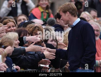 Prince William shakes hands with a well-wisher as crowds gathered to witness the Prince arriving at St. Andrews University, St. Andrews, Scotland, where he is to study an art history degree. He was accompanied by his father Prince Charles, The Duke of Rothesay. Stock Photo