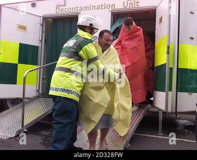 Postal workers who came in contact with a suspicious substance at a sorting office in Liverpool being helped to leave Merseyside Ambulance decontamination unit.   * ..... London's Metropolitan Police said that the public should be vigilant over a possible terrorist threat but should not panic. A spokeswoman said that if people are suspicious of anything they have received in the mail or by hand they should contact police. Stock Photo