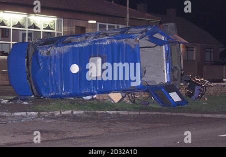 A wheelchair lies on a grass verge beside an overturned minibus van which was carrying disabled adults, when it was in collision with a lorry on the main Londonderry to Toome bridge road on the outskirts of Toome village.  * Three people on the bus have been cofirmed dead, and police say they have arrested a lorry driver in connection with the crash. Stock Photo