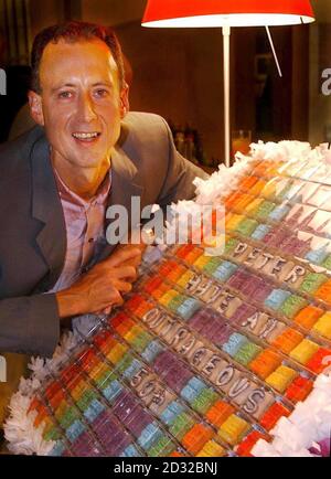 Human-rights campaigner, Peter Tatchell, celebrates his 50th birthday, next to a huge cake, at a party thrown for him  at the Royal Festival Hall, London. Stock Photo