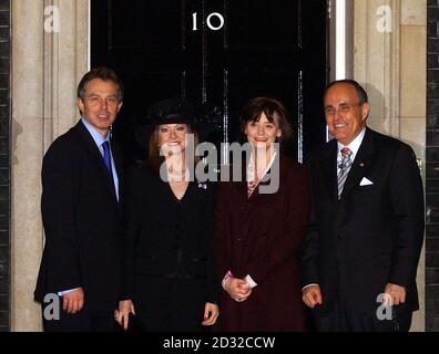 The former mayor of New York city Rudolph Giuliani, right, at 10 Downing Street, after receiving a Knighthood from Queen Elizabeth II at Buckingham Palace earlier in the day. From left to right, Tony Blair, Judith Nathan, Cherie Blair and Rudolph Giuliani. * During an earlier lunch held in his honour Mr Giuliani was told that Britons had raised nearly 5 million for the victims of the September 11 attacks in New York. The money will be used to help children who lost a parent in the atrocities and also families of the 61 British victims, said Lord Levene, chairman of the appeal fund set up i Stock Photo