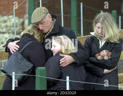 John Shakespeare, whose son Robert was killed in the Selby rail crash, comforts his widow Julie and daughters Laura (right) and Kerrie, centre, as they attend a Memorial Service for the victims of the crash at the scene of the accident, * to mark the first anniversary of the tragedy in which ten people lost their lives. Earlier today survivors and relatives of the victims met at the scene of the disaster for an act of remembrance. Around 25 people gathered at the Great Heck site in North Yorkshire at 6.15am - the exact time when the disaster occurred on February 28 last year. Stock Photo