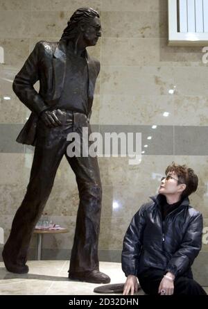Yoko Ono, the widow of former Beatle John Lennon, unveils a statue of her late husband on the upper concourse of  Liverpool's John Lennon Airport. She was joined at the unveiling with Cherie Booth. The statue is the work of sculptor Tom Murphy. Stock Photo