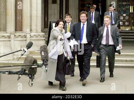 Piers Morgan (centre), editor of The Mirror, leaves the High Court in London after supermodel Naomi Campbell won 3,500 damages from the newspaper following a ruling that it acted in breach of confidence in publishing details of her therapy at Narcotics Anonymous. Stock Photo
