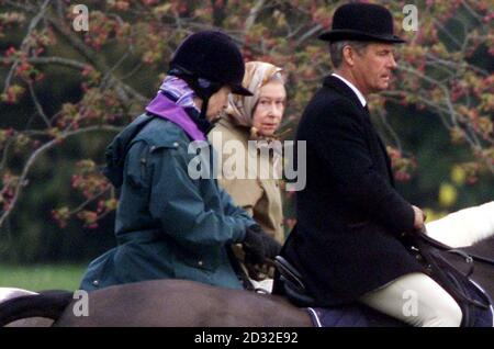 Britain's Queen Elizabeth II (centre) rides with her daughter, the Princess Royal (left) and an unidentified aide near Windsor Castle.  The coffin of the Queen Elizabeth, the Queen Mother, who died Saturday aged 101, will be brought from WIndsor later Tuesday to London.   Stock Photo